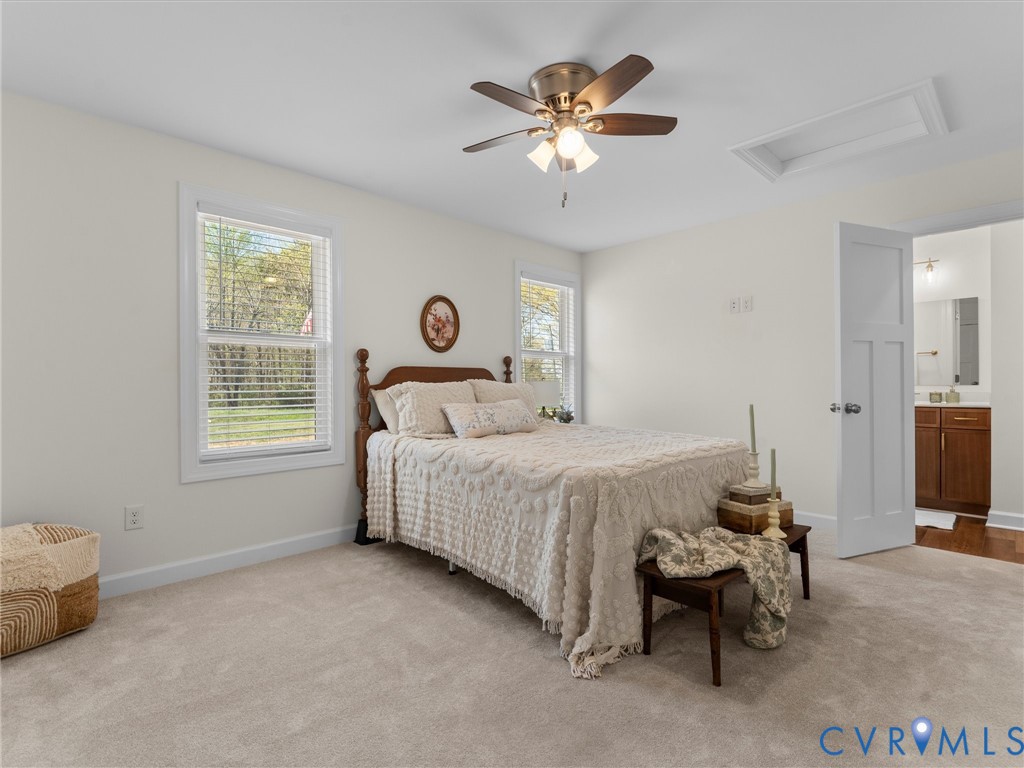 143 High School Road Buckingham, VA 23921 - Photo 31 of 50 a bedroom with a bed and a chandelier
