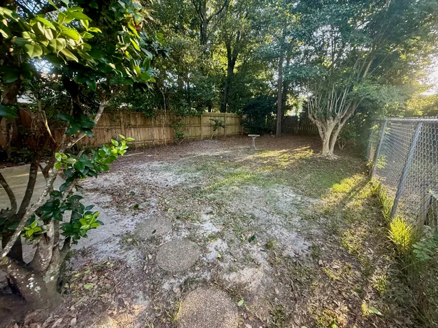 a view of a backyard with large trees