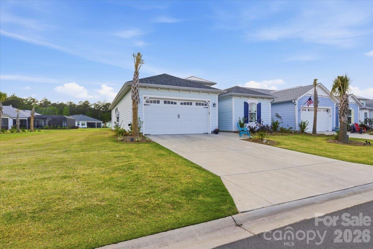 859 Ocean Hammock Loop Hardeeville, SC 29927 - Photo 1 of 33 a front view of a house with a yard