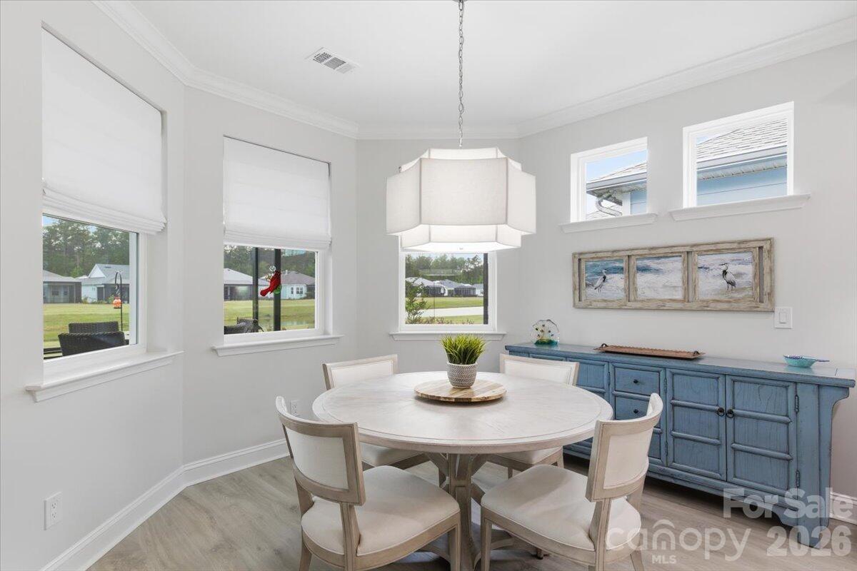 859 Ocean Hammock Loop Hardeeville, SC 29927 - Photo 11 of 33 a view of a dining room with furniture window and wooden floor
