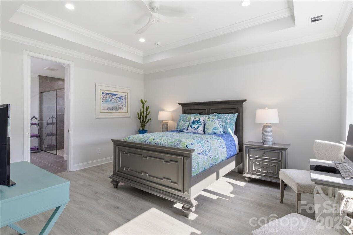 859 Ocean Hammock Loop Hardeeville, SC 29927 - Photo 12 of 33 a bedroom with a bed and a chair