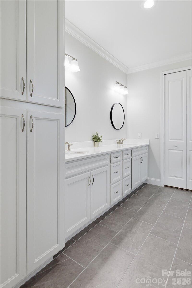 859 Ocean Hammock Loop Hardeeville, SC 29927 - Photo 16 of 33 a spacious bathroom with a double vanity sink and a mirror