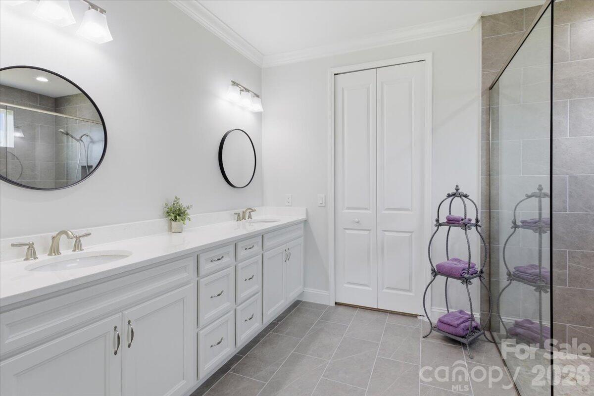 859 Ocean Hammock Loop Hardeeville, SC 29927 - Photo 17 of 33 a bathroom with a double vanity sink and a mirror