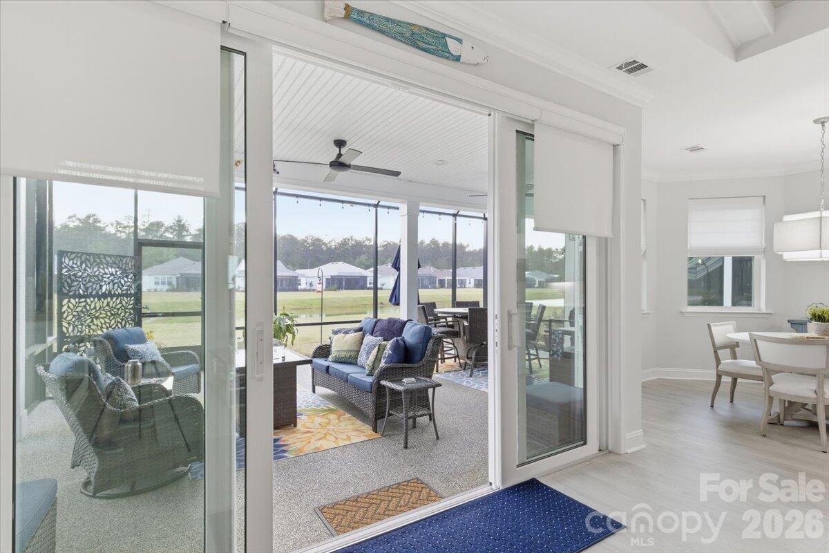 859 Ocean Hammock Loop Hardeeville, SC 29927 - Photo 29 of 33 a living room with furniture and a floor to ceiling window