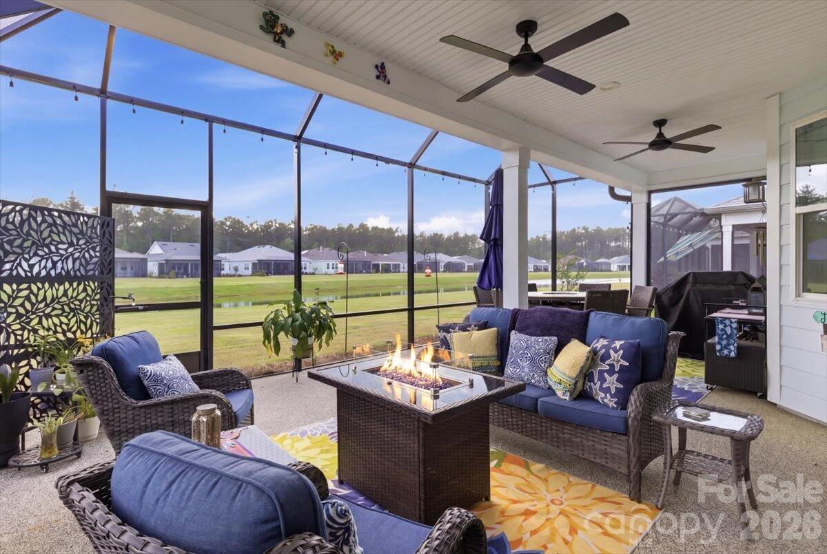 859 Ocean Hammock Loop Hardeeville, SC 29927 - Photo 30 of 33 a living room with furniture and a floor to ceiling window