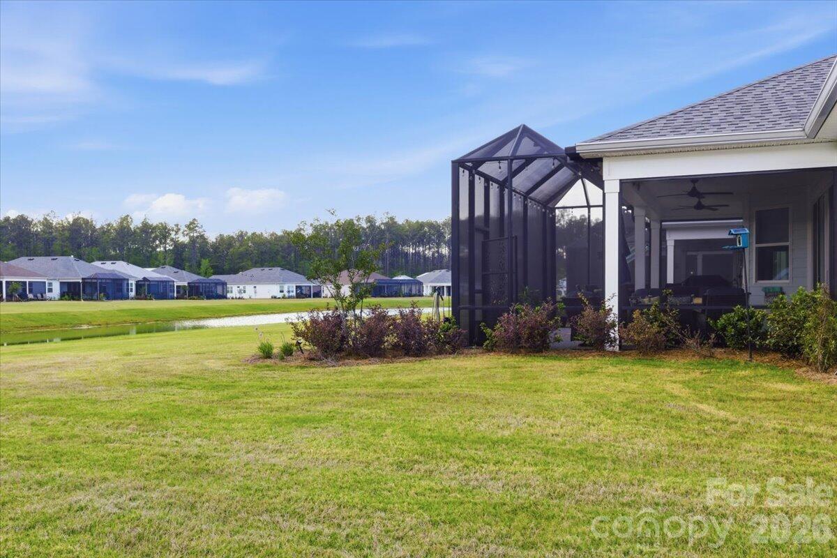 859 Ocean Hammock Loop Hardeeville, SC 29927 - Photo 31 of 33 a view of a house with a big yard and large trees