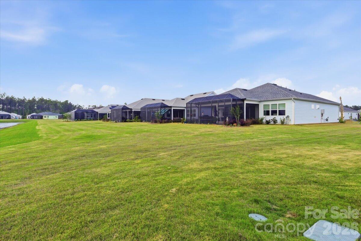 859 Ocean Hammock Loop Hardeeville, SC 29927 - Photo 32 of 33 a view of a house with a yard and sitting area
