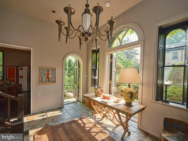 a view of a workspace with furniture window and wooden floor
