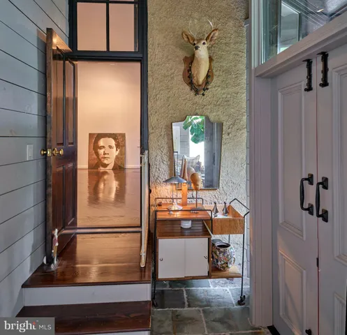 a kitchen with a table chairs and refrigerator
