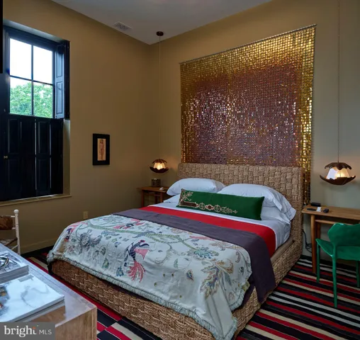 a bathroom with a tub sink toilet and a window