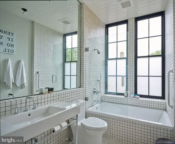 a living room with a rug and a fireplace