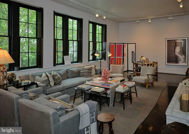 a living room with furniture and large windows