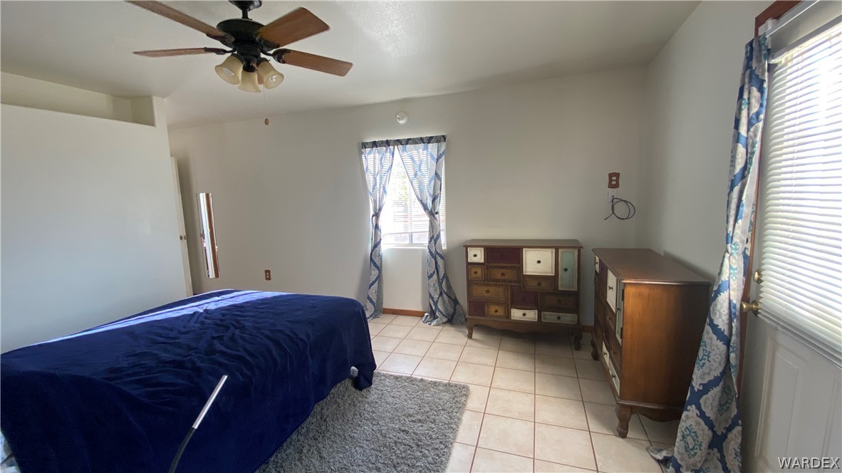 171 South Horn Road Golden Valley, AZ 86413 - Photo 34 of 46 a bedroom with a bed and window