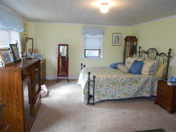 51 Main Road Westhampton, MA 01027 - Photo 18 of 29 a bedroom with a bed and a flat tv screen on the dresser