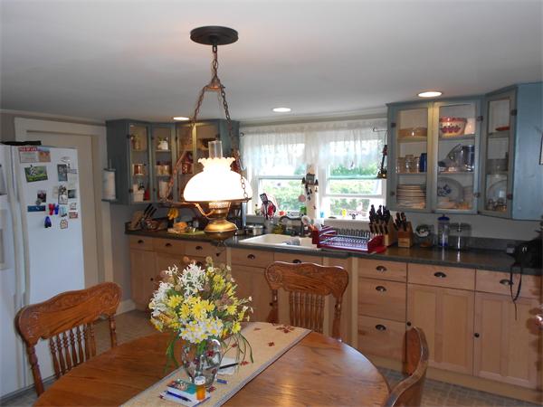 51 Main Road Westhampton, MA 01027 - Photo 3 of 29 a kitchen with sink refrigerator dining table and chairs