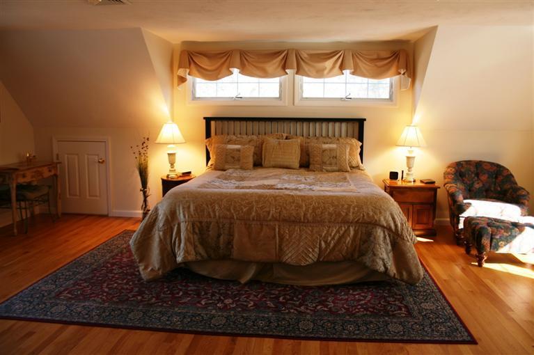 150 Blue Heron Road Wellfleet, MA 02667 - Photo 14 of 35 a bedroom with a bed rug and wooden floor