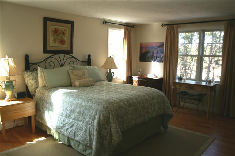 150 Blue Heron Road Wellfleet, MA 02667 - Photo 23 of 35 a bedroom with a bed and glass window