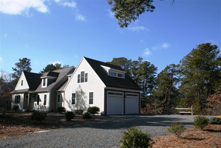 150 Blue Heron Road Wellfleet, MA 02667 - Photo 27 of 35 a front view of a house with a yard