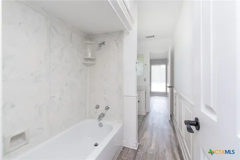 a bathroom with a bathtub and shower