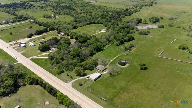 an aerial view of a residential houses with outdoor space