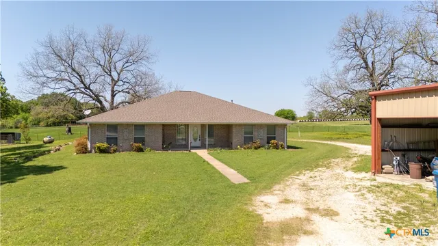 a view of a house with a yard and sitting area