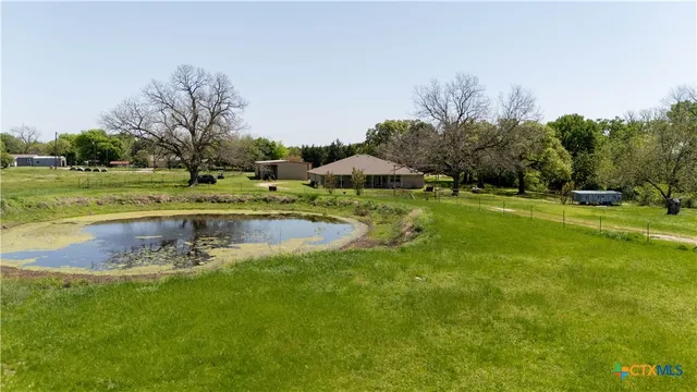 a view of a swimming pool with a yard