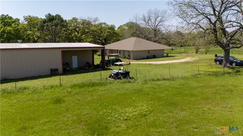 a view of a swimming pool with lawn chairs under an umbrella
