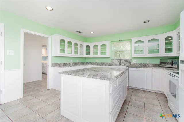 a kitchen with a stove a sink and a refrigerator