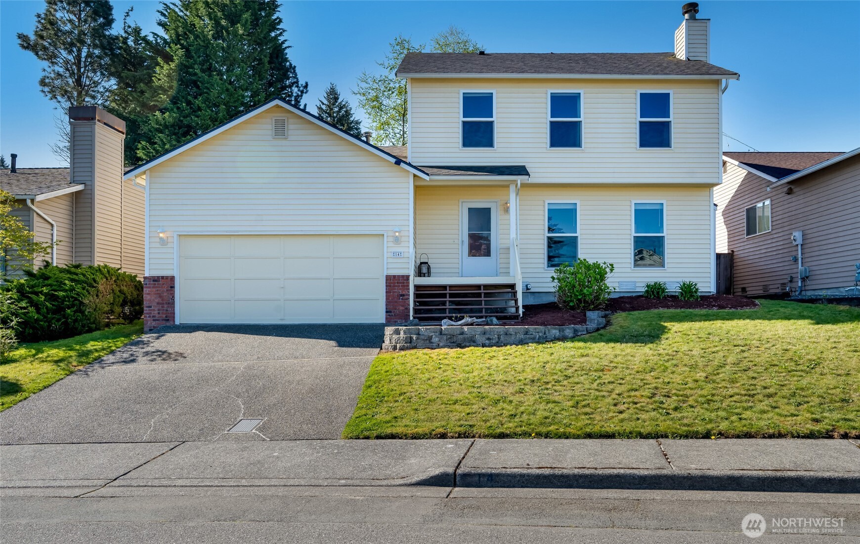 a view of a house with a yard and plants