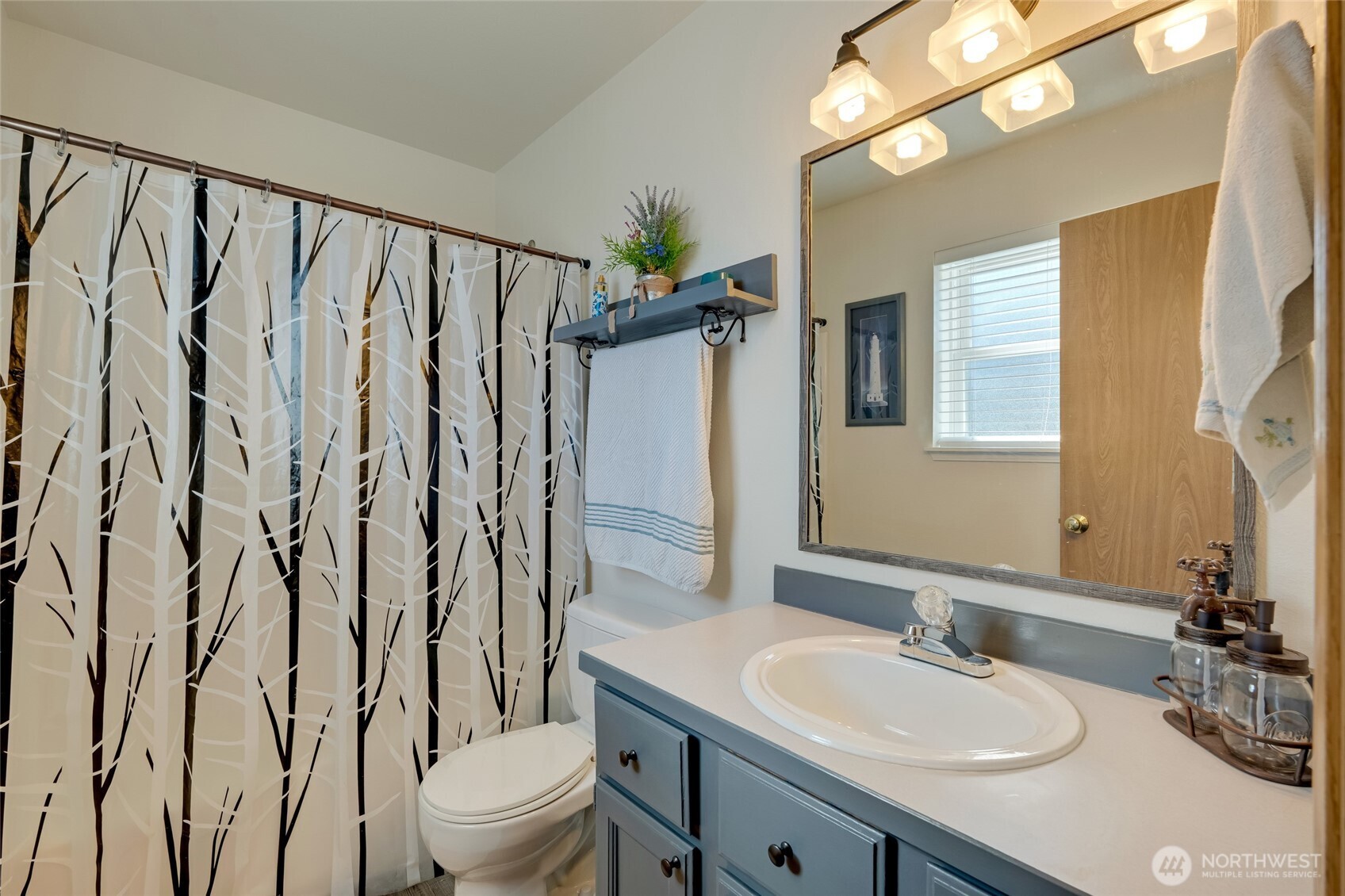 14 60th Place Southeast Everett, WA 98203 - Photo 22 of 35 a bathroom with a granite countertop sink toilet a mirror a vanity and shower