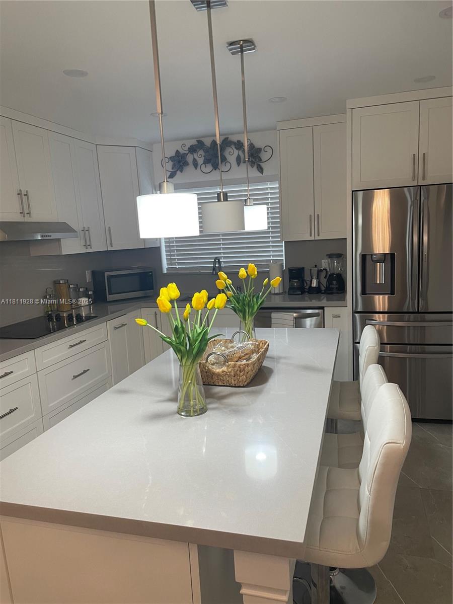 19700 Southwest 184th Street Miami, FL 33187 - Photo 11 of 52 a kitchen with stainless steel appliances granite countertop a sink a stove and a refrigerator