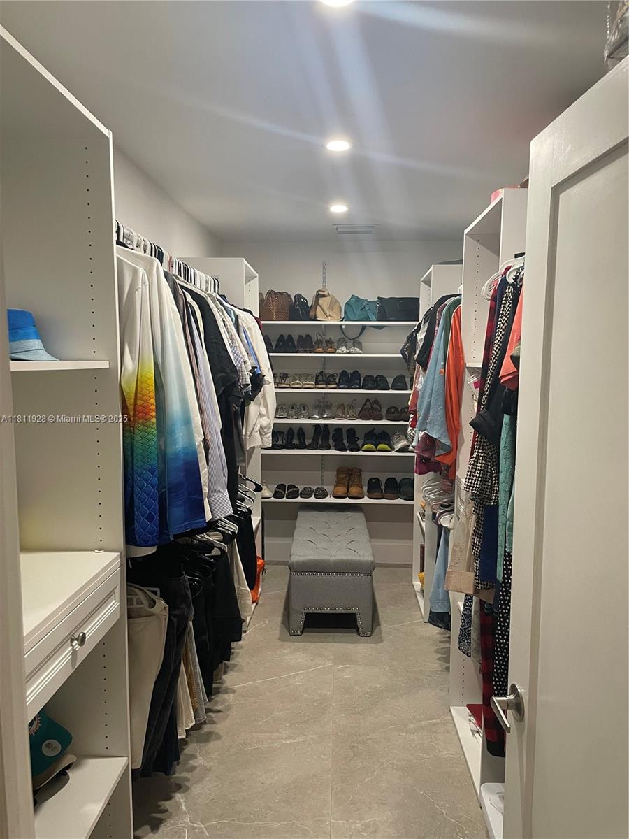 19700 Southwest 184th Street Miami, FL 33187 - Photo 17 of 52 a view of walk in closet with clothes and shoes