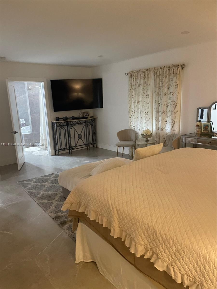 19700 Southwest 184th Street Miami, FL 33187 - Photo 19 of 52 a bedroom with a bed and a flat screen tv