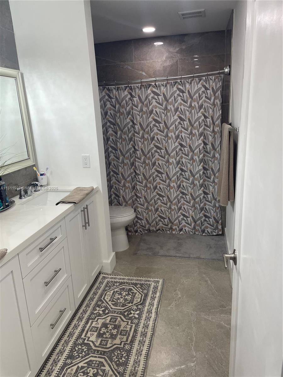 19700 Southwest 184th Street Miami, FL 33187 - Photo 20 of 52 a bathroom with a toilet and a sink