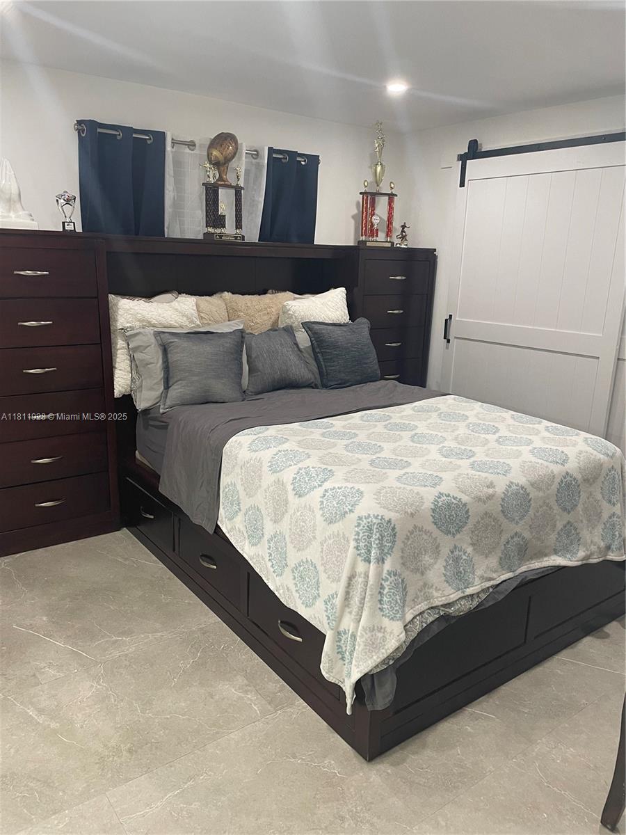19700 Southwest 184th Street Miami, FL 33187 - Photo 21 of 52 a large bed sitting in a bedroom and dresser