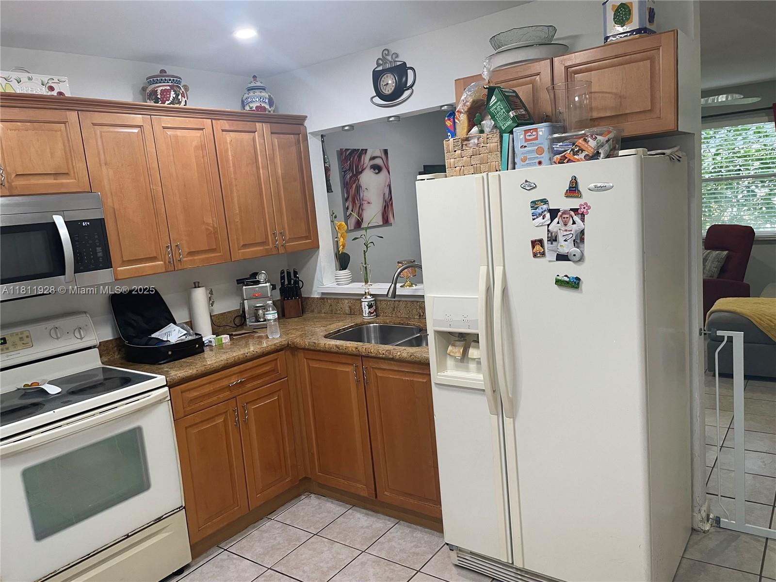 19700 Southwest 184th Street Miami, FL 33187 - Photo 25 of 52 a white refrigerator freezer sitting inside of a kitchen