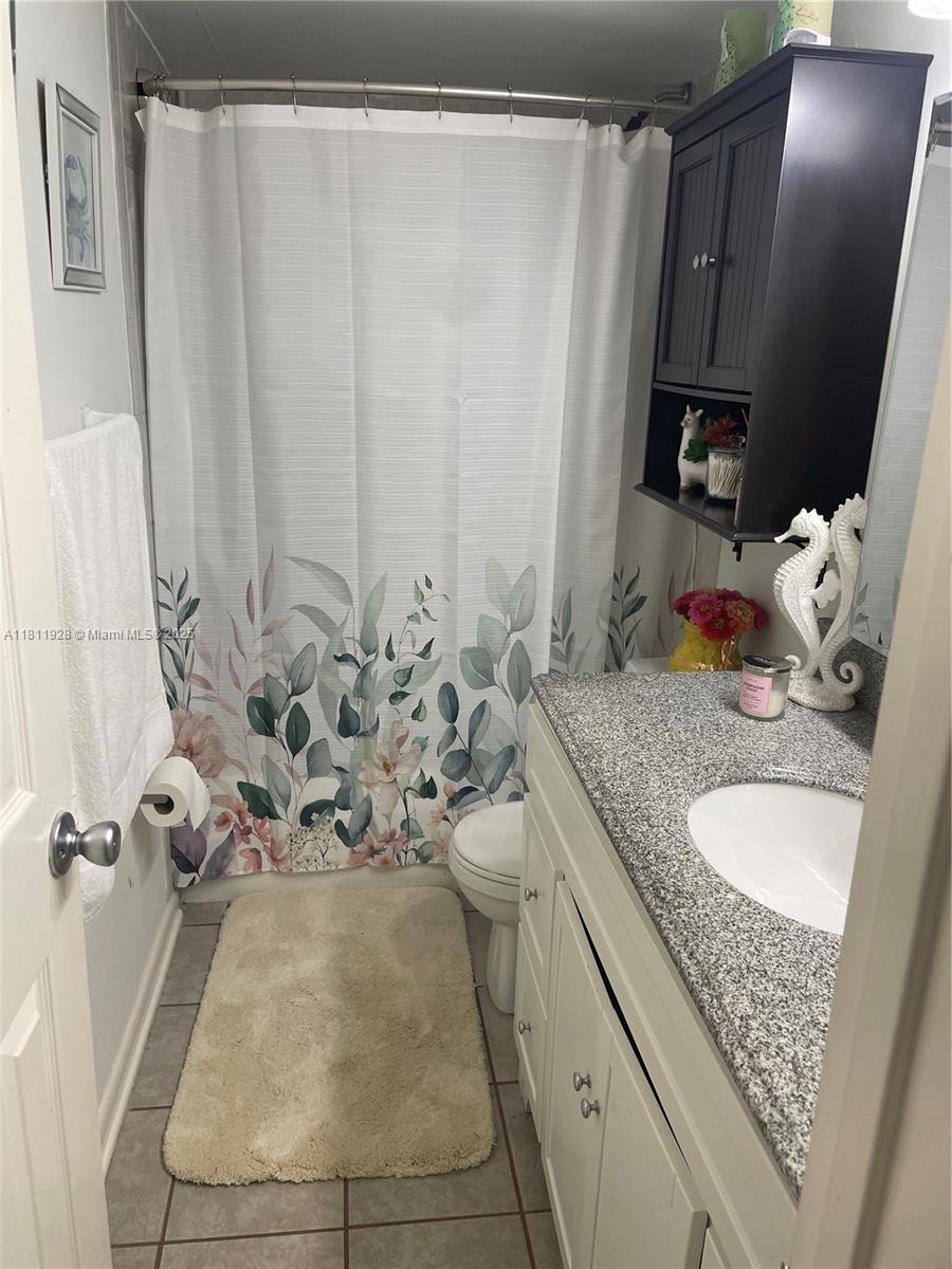 19700 Southwest 184th Street Miami, FL 33187 - Photo 28 of 52 a bathroom with a granite countertop sink and a mirror