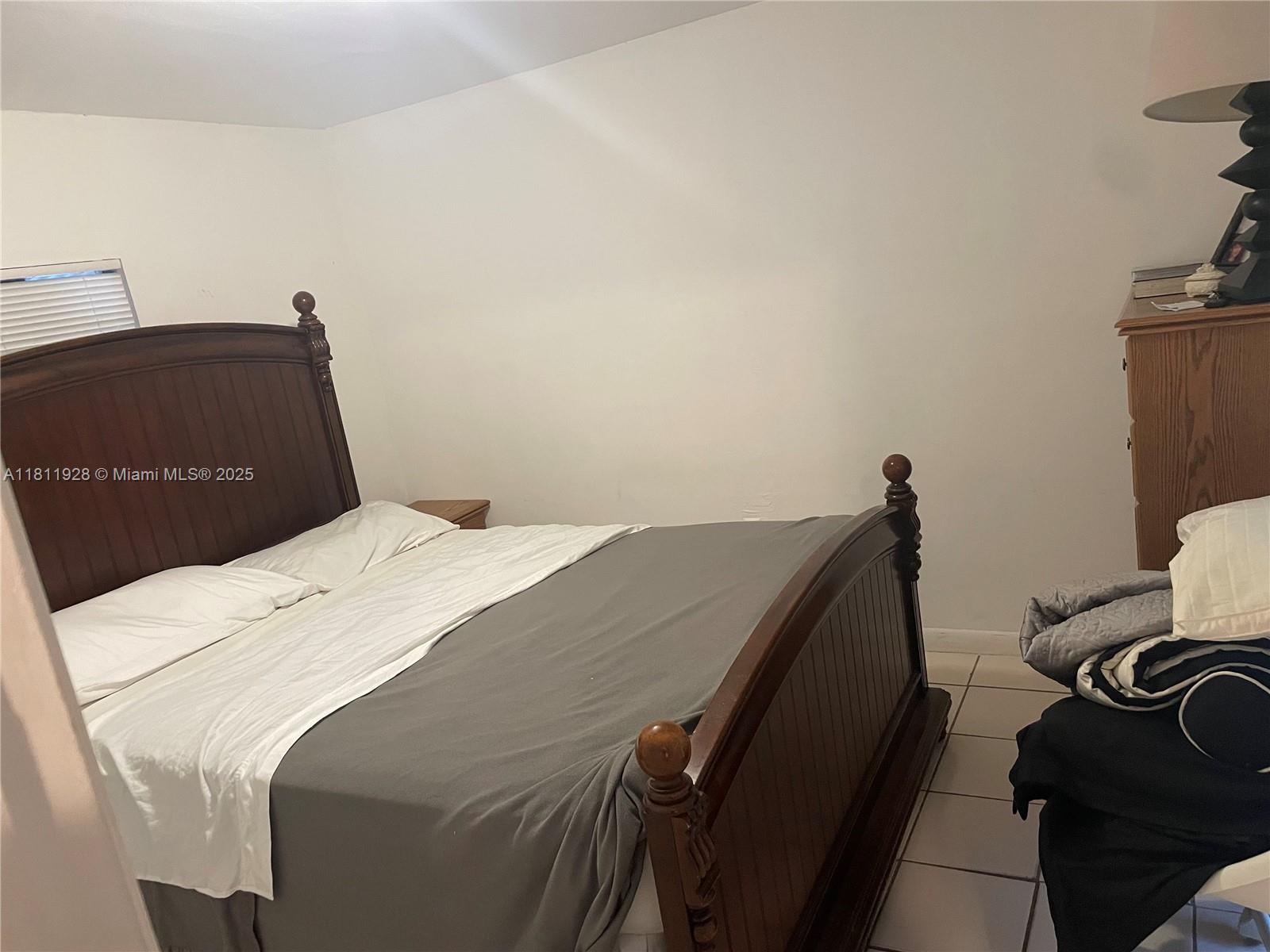 19700 Southwest 184th Street Miami, FL 33187 - Photo 33 of 52 a bedroom with a bed and a mirror