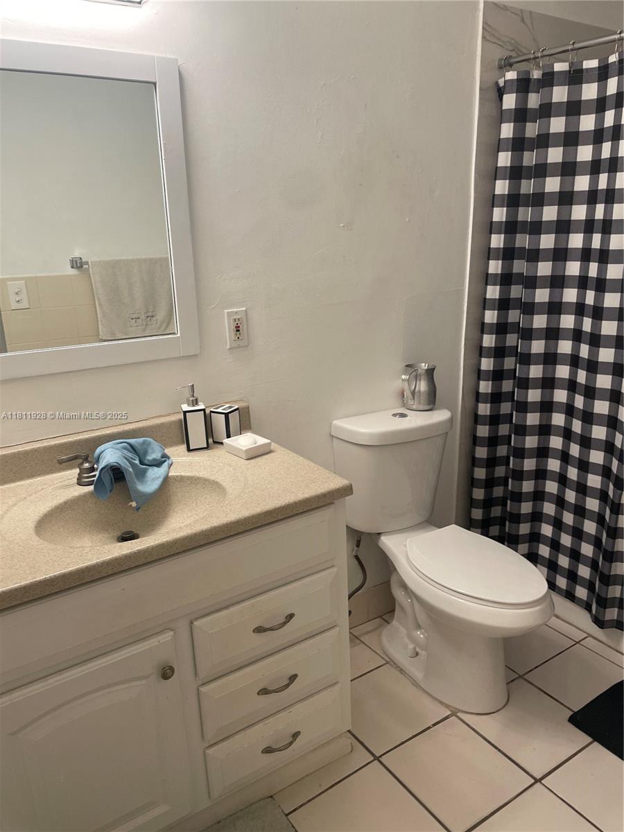 19700 Southwest 184th Street Miami, FL 33187 - Photo 34 of 52 a bathroom with a sink toilet and vanity