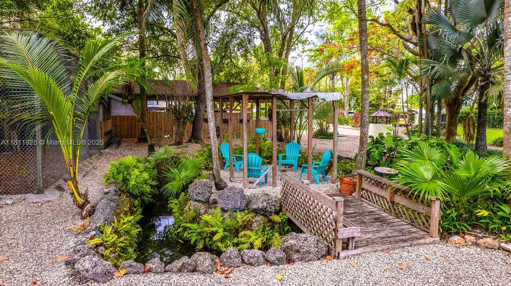19700 Southwest 184th Street Miami, FL 33187 - Photo 44 of 52 a view of a chairs and table in the garden