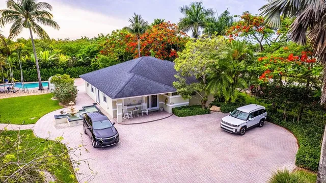 a view of a chair and table in backyard of the house