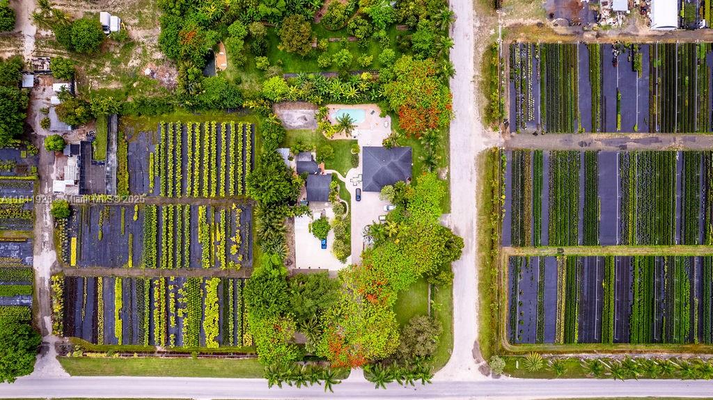 19700 Southwest 184th Street Miami, FL 33187 - Photo 51 of 52 a view of a house with a small yard and wooden fence