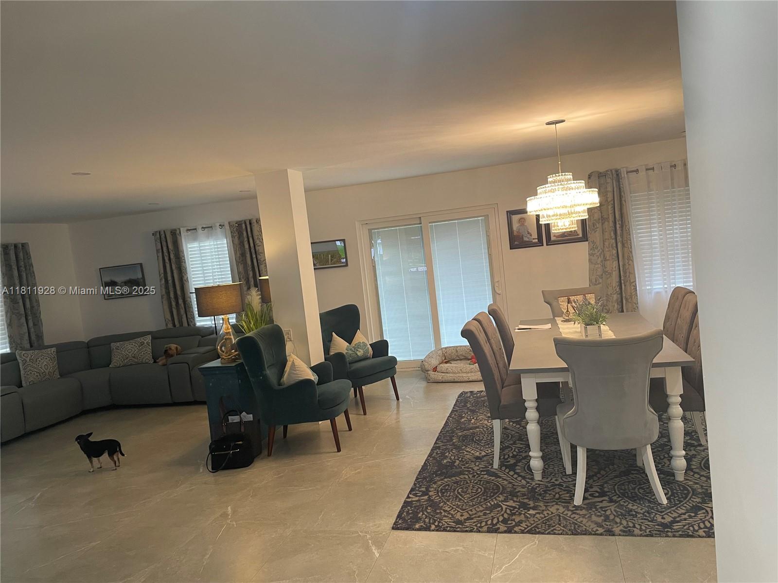 19700 Southwest 184th Street Miami, FL 33187 - Photo 9 of 52 a living room with furniture and a dining table with wooden floor
