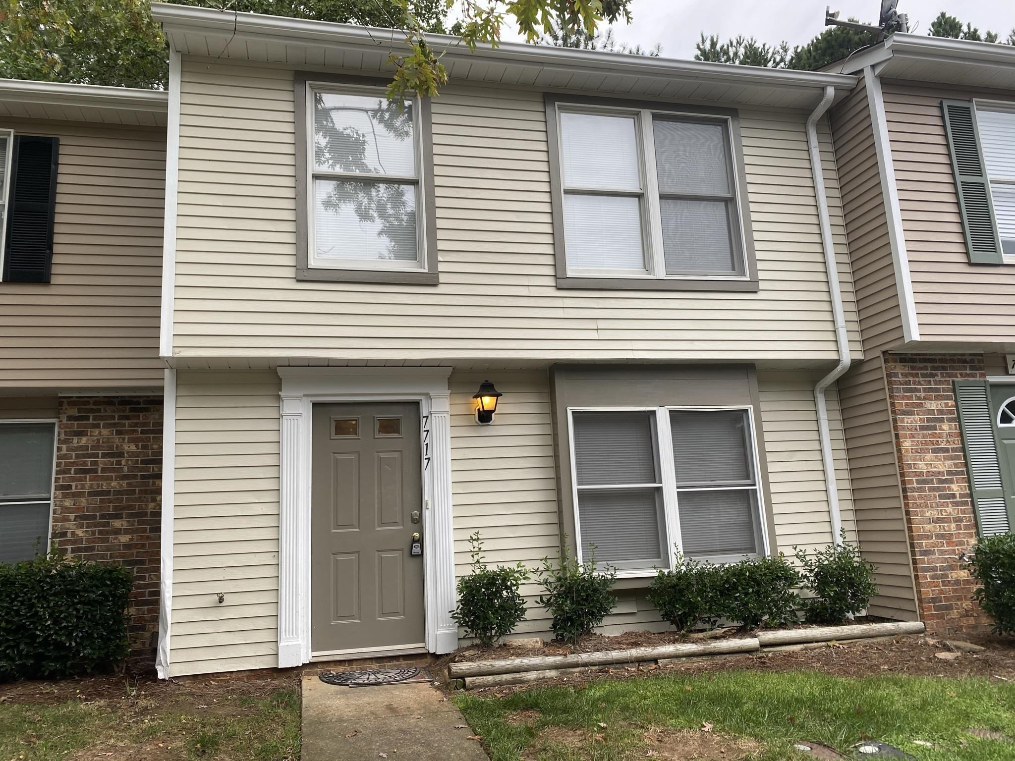 7717 Bernadette Lane Raleigh, NC 27615 - Photo 1 of 26 a front view of a house with garden