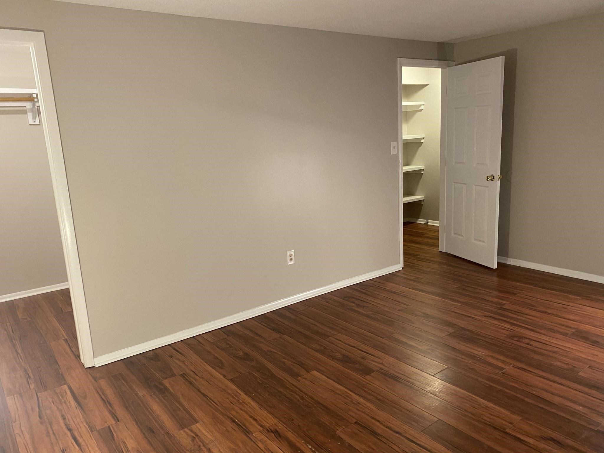 7717 Bernadette Lane Raleigh, NC 27615 - Photo 18 of 26 an empty room with wooden floor and windows