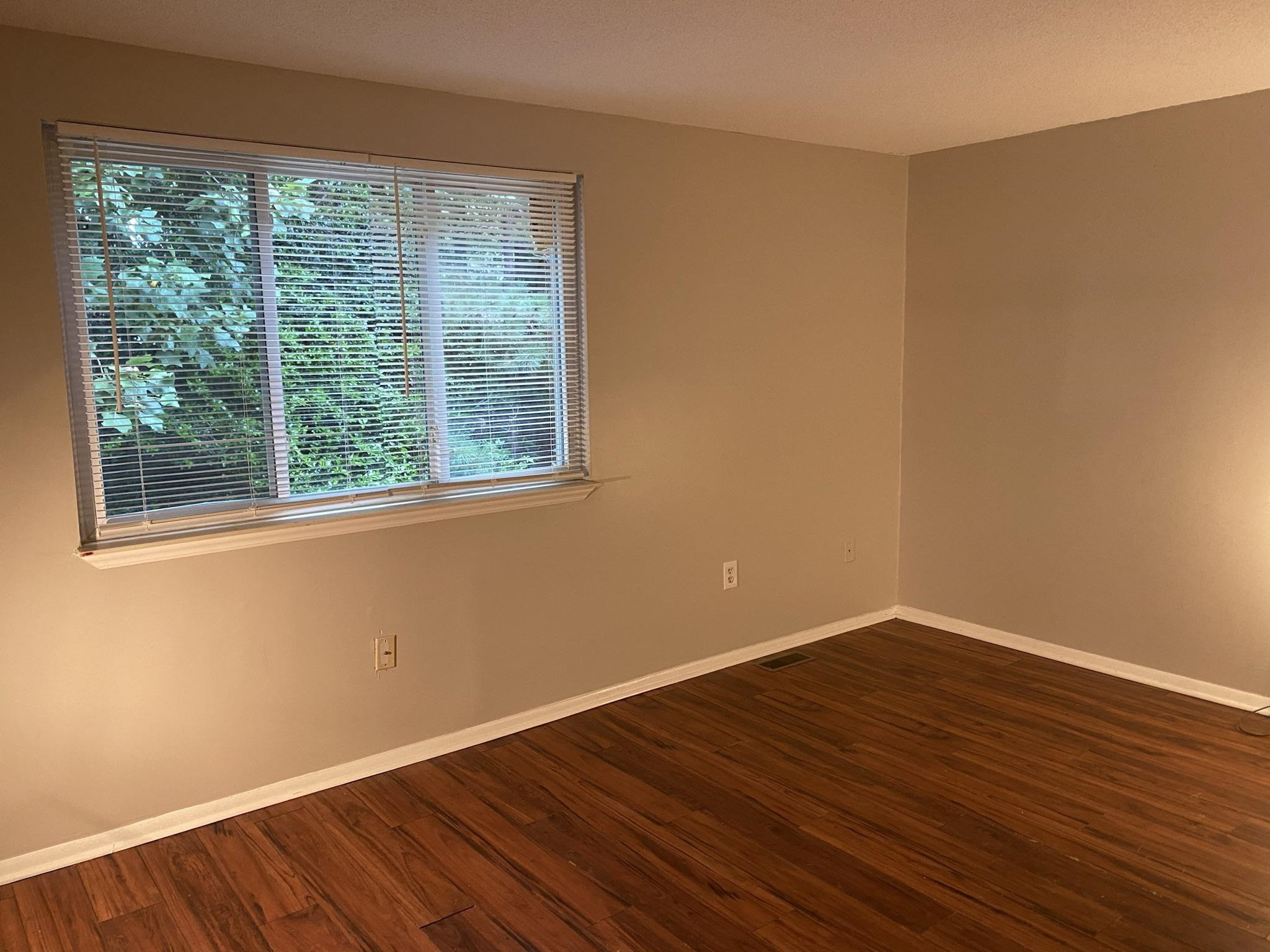 7717 Bernadette Lane Raleigh, NC 27615 - Photo 20 of 26 a view of a room with wooden floor and a window