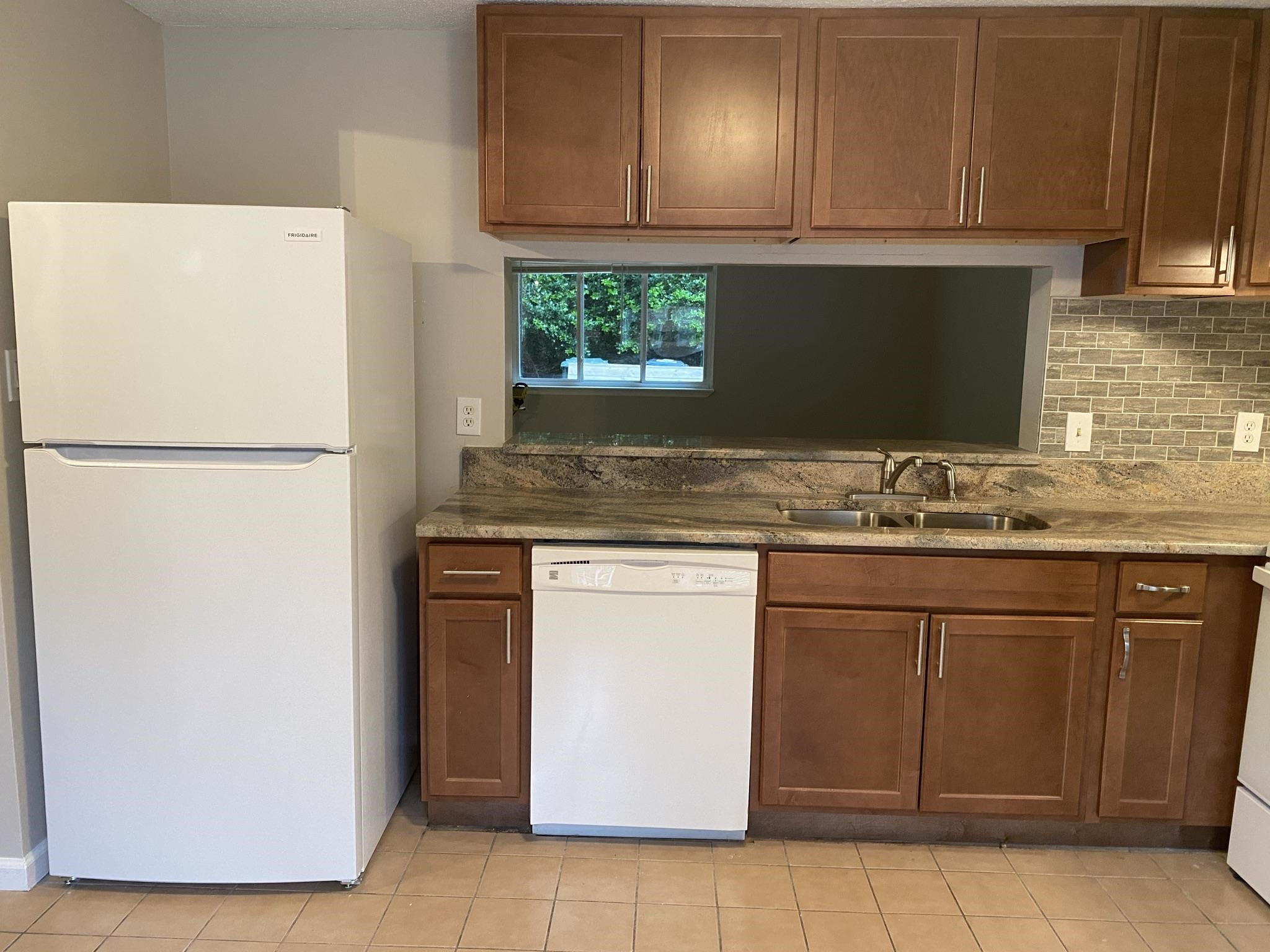 7717 Bernadette Lane Raleigh, NC 27615 - Photo 6 of 26 a white refrigerator freezer sitting inside of a kitchen