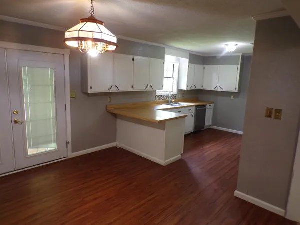 a kitchen with stainless steel appliances granite countertop wooden floors and sink