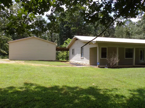 a front view of house with yard and green space