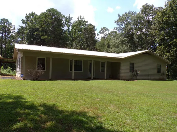 a front view of house with yard and green space